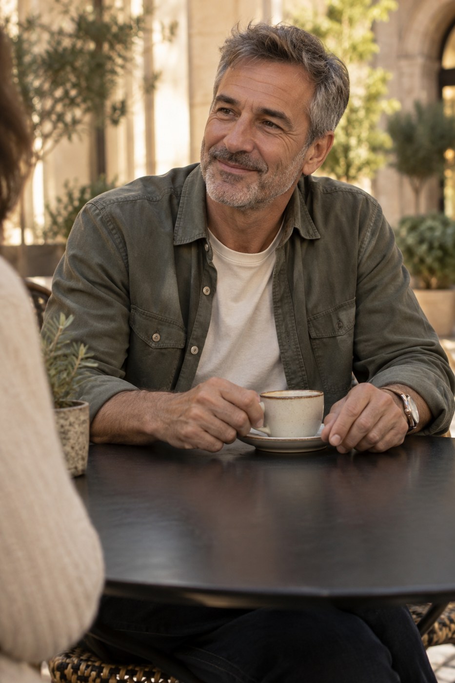 A man enjoying a relaxed café conversation